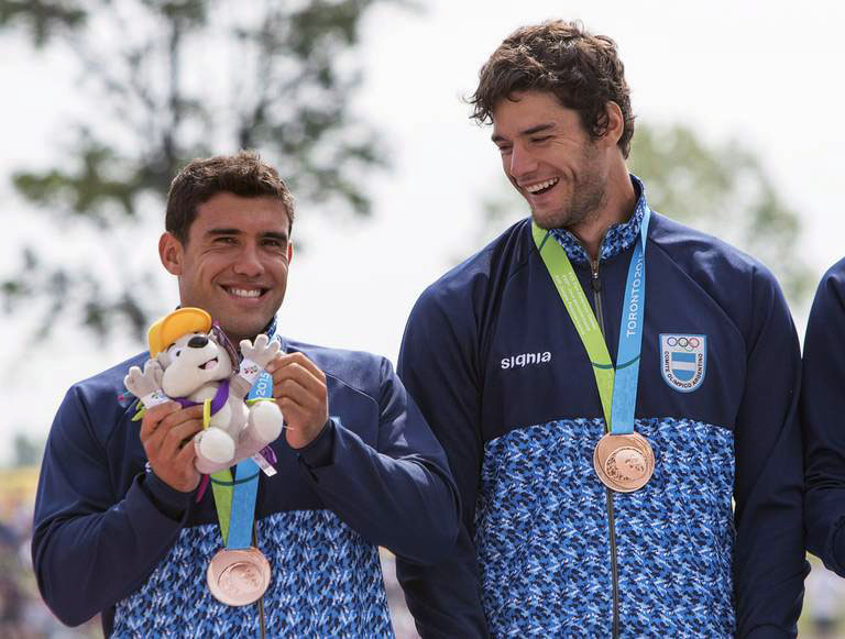 Members of Argentina's K4 team Juan Ignacio Caceres, left, and Gonzalo Carreras celebrate winning the bronze medal in the 1000m kayaking final at the 2015 Pan Am Games in Welland, Ont., Sunday, July 12, 2015. THE CANADIAN PRESS/Aaron Lynett
