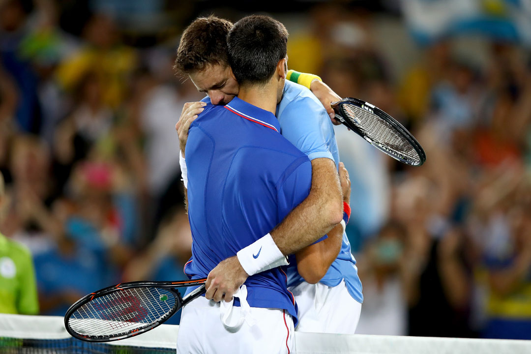 RIO DE JANEIRO, BRAZIL - AUGUST 07: Juan Martin Del Potro of Argentina is congratulated by Novak Djokovic of Serbia after his victory in their singles match on Day 2 of the Rio 2016 Olympic Games at the Olympic Tennis Centre on August 7, 2016 in Rio de Janeiro, Brazil. (Photo by Clive Brunskill/Getty Images)