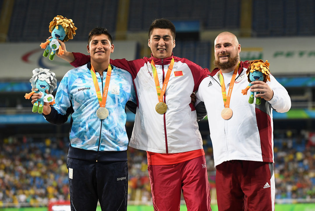 RIO DE JANEIRO, BRAZIL - SEPTEMBER 12: (L to R) Silver medalist Hernan Emanuel Urra of Argentina, Gold medalist Fu Xinhan of China and Bronze medalist Edgars Bergs of Latvia celebrate on the podium at the medal ceremony for the Mne's Shot Put - F35 on day 5 of the Rio 2016 Paralympic Games at the Olympic Stadium on September 12, 2016 in Rio de Janeiro, Brazil. (Photo by Atsushi Tomura/Getty Images for Tokyo 2020)